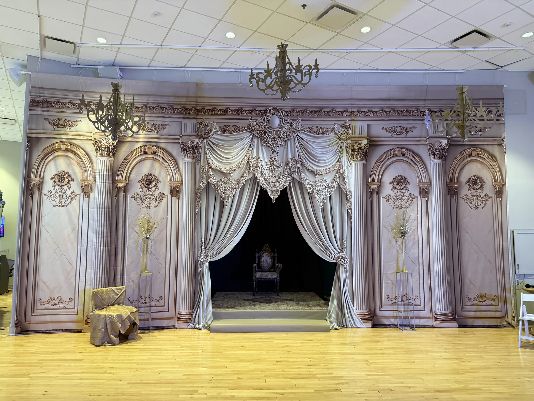 Ornate theater-style backdrop and chandeliers inside Midtown Ballroom